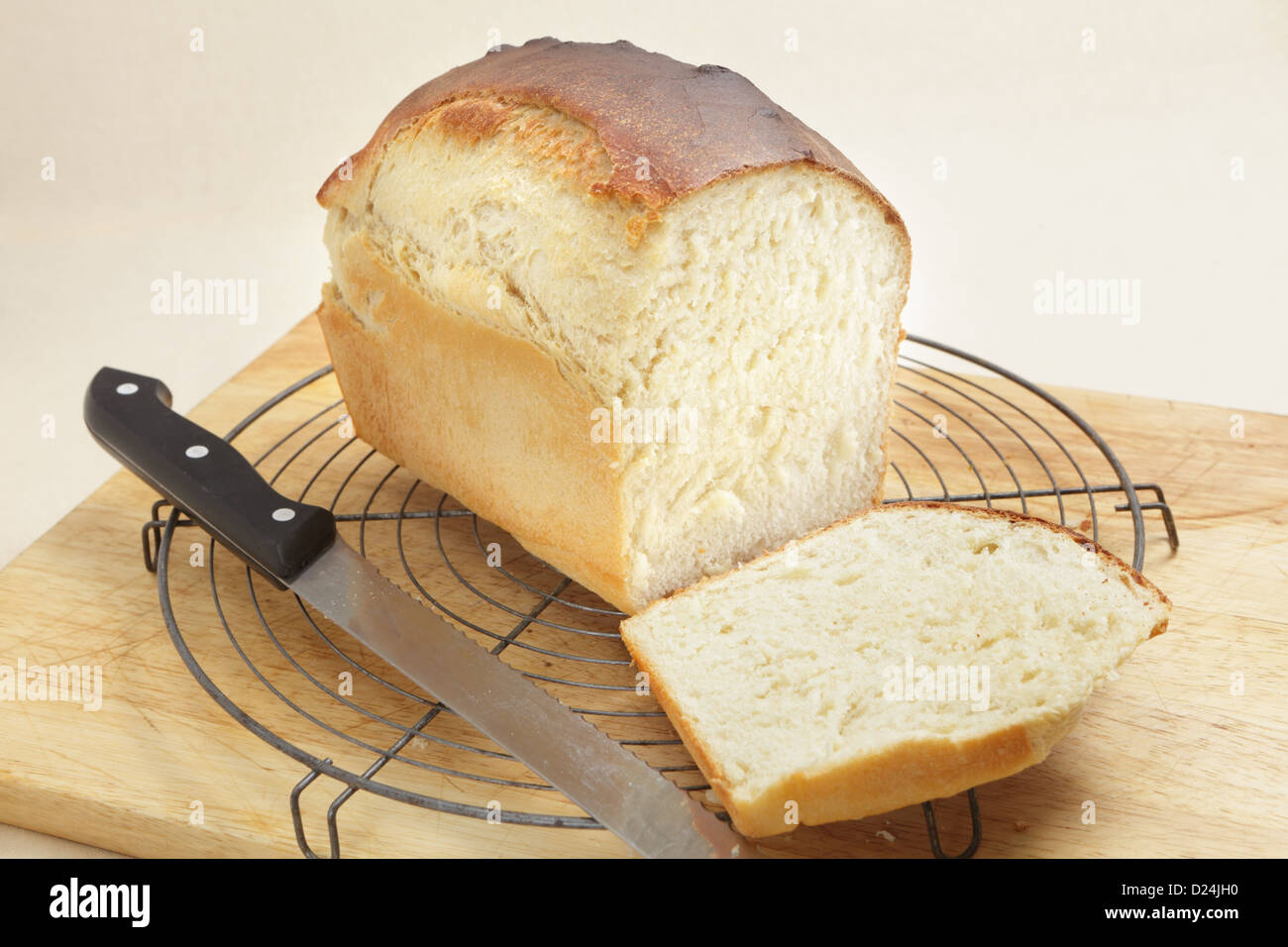 A loaf of freshly-baked homemade bread with the end cut from it to show the texture Stock Photo