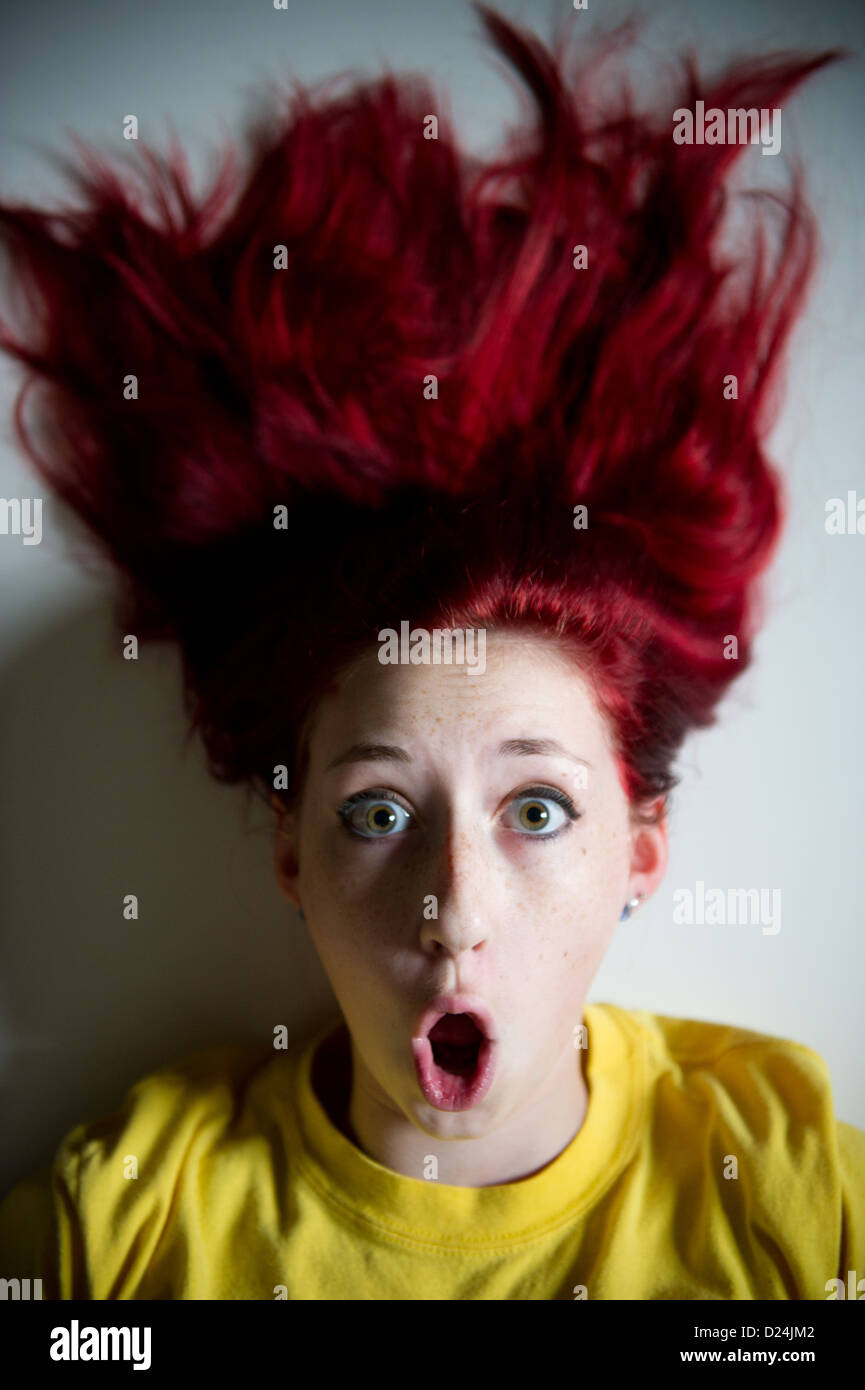 Young girl with brightly colored hair making facial expressions  Stock Photo