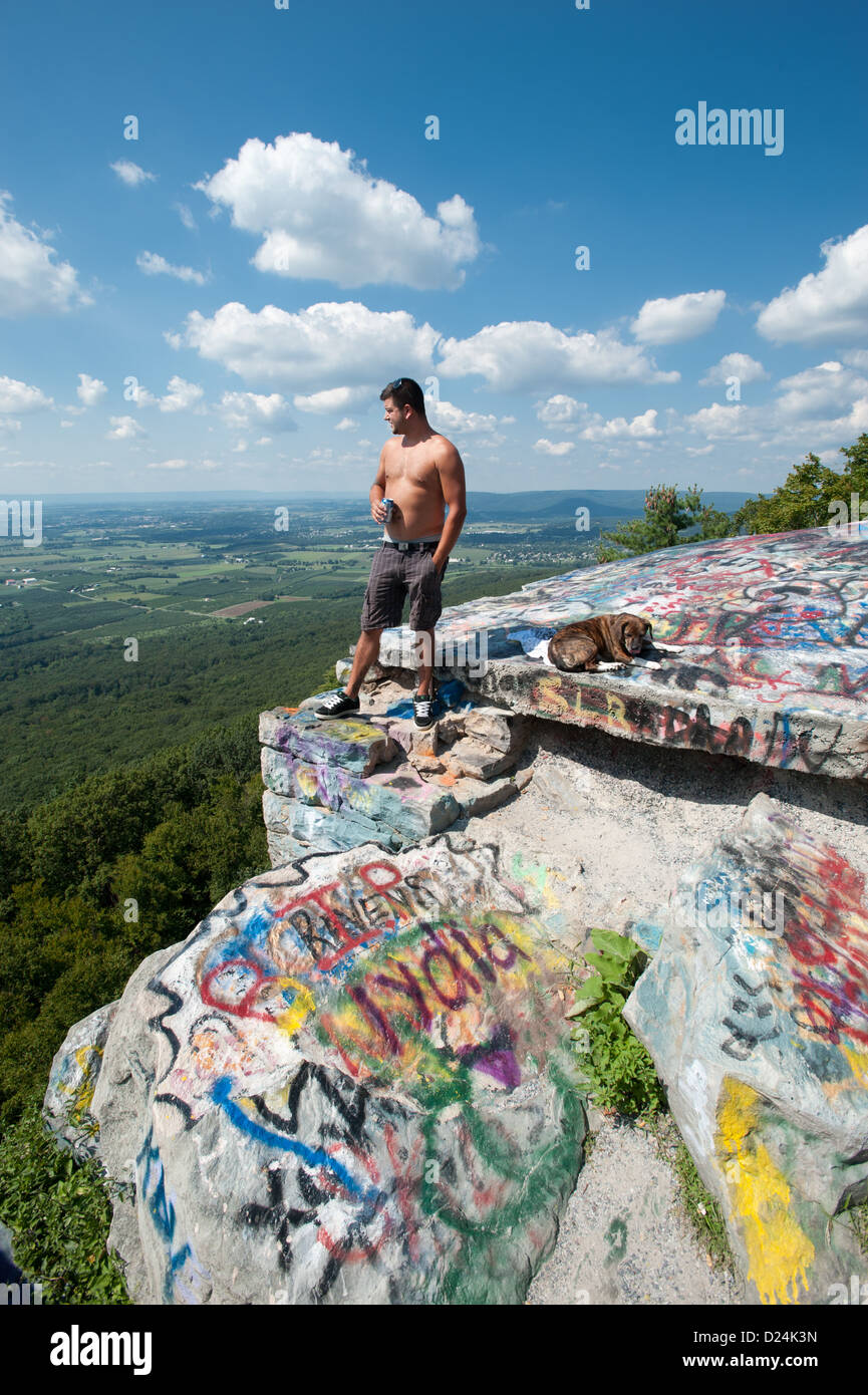 Man and dog standing at scenic overlook, view of Pen Mar, Maryland Mason Dixon Line Stock Photo