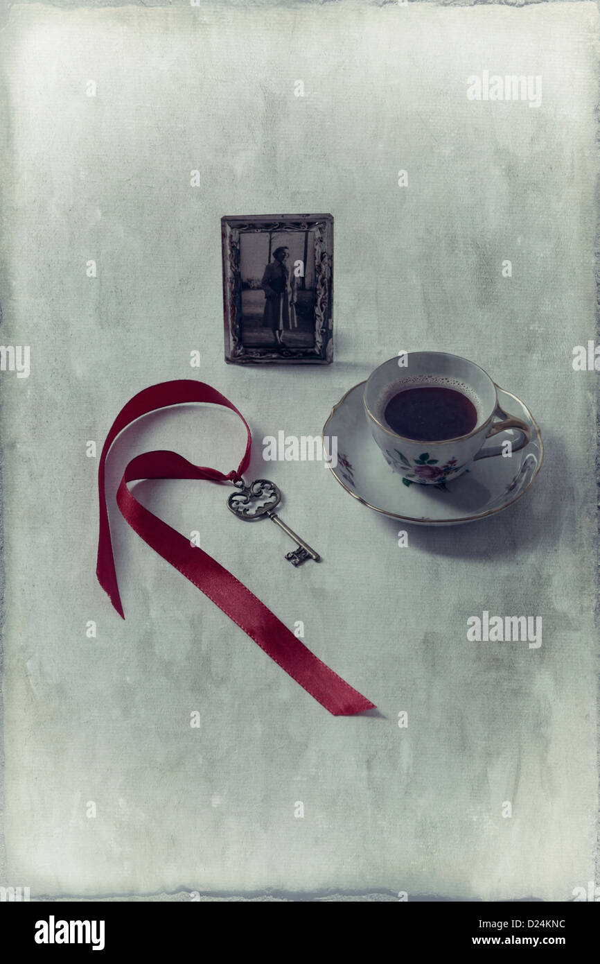 a cup of coffee with an old photo and an old key Stock Photo