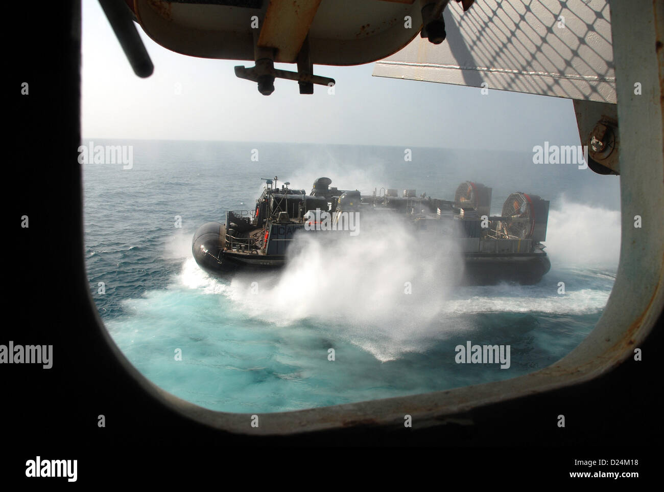 A landing craft, air cushion (LCAC) departs amphibious transport dock ship USS Green Bay (LPD 20).  Green Bay is part of the Peleliu Amphibious Ready Group and, with embarked 15th Marine Expeditionary Unit, is deployed in support of maritime security operations and theater security cooperation efforts in the U.S. 5th Fleet area of responsibility. . Jan 14, 2013  (U.S. Navy photo) Stock Photo