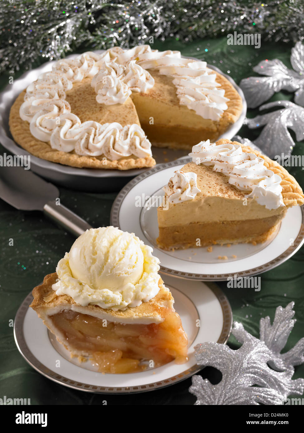 Pumpkin and apple pie slices with a whole pumpkin pie Stock Photo