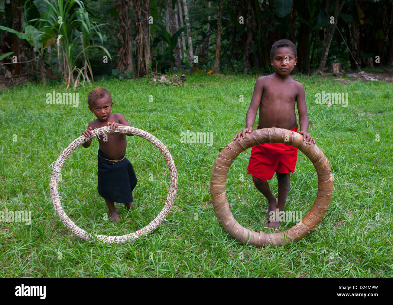 Kids Holding A Giant Shell Money, East New Britain, Papua New Guinea Stock Photo