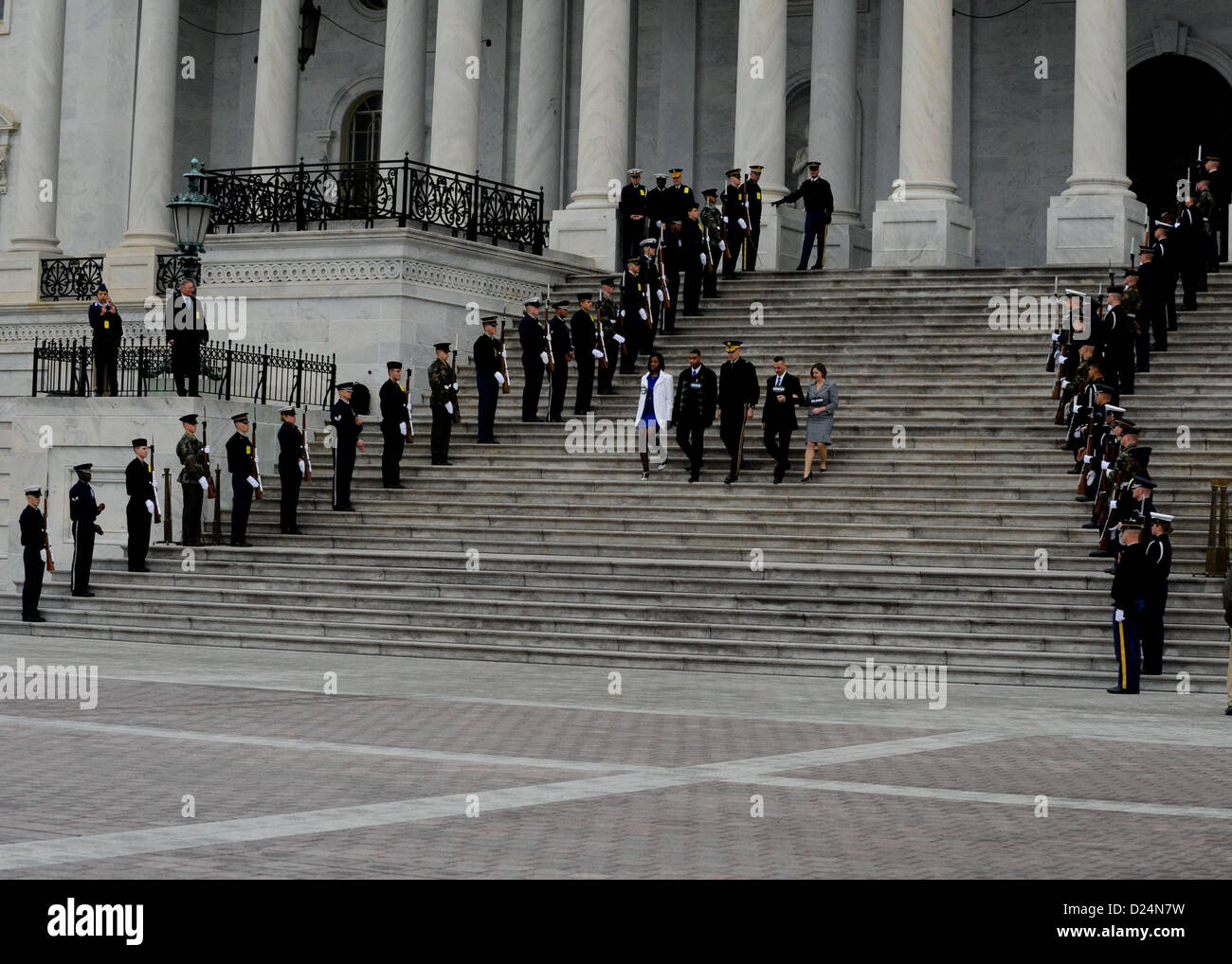 A joint honor guard salutes as role players representing the president, vice president and their spouses descend the U.S. Capitol steps during the presidential inauguration dress rehearsal in Washington, D.C., Jan. 13, 2013. Military involvement in the presidential inauguration dates back to April 30, 1789, when members of the U.S. Army, local militia units and revolutionary war veterans escorted George Washington to his first inauguration ceremony. (DoD Photo by  Staff Sgt. Wesley Farnsworth) (Released) Stock Photo