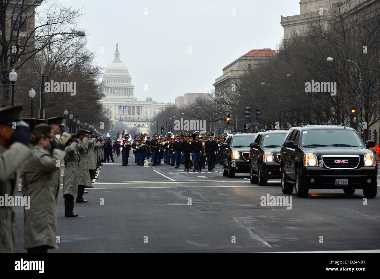 The Marine Corps street cordon salutes as vehicles representing the official party transit along Pennsylvania Avenue during the dress rehearsal for the presidential inaugural parade in Washington, D.C., Jan. 13, 2013. Military involvement in the presidential inauguration dates back to April 30, 1789, when members of the U.S. Army, local militia units and revolutionary war veterans escorted George Washington to his first inauguration ceremony.(DoD Photo by Cpl. Christina O'Neil) (Released) Stock Photo