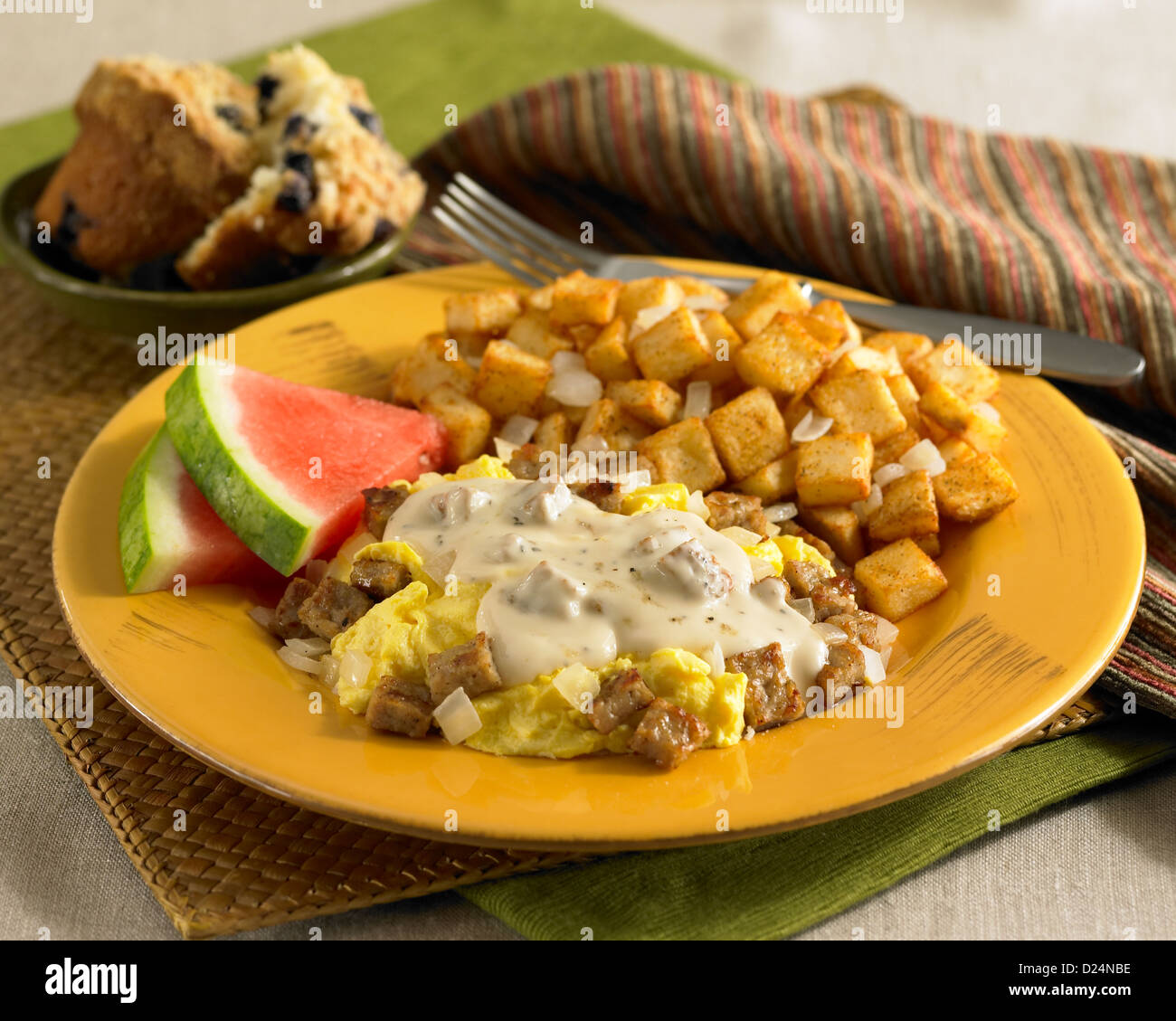 Scrambled egg breakfast with sausage gravy served with potatoes
