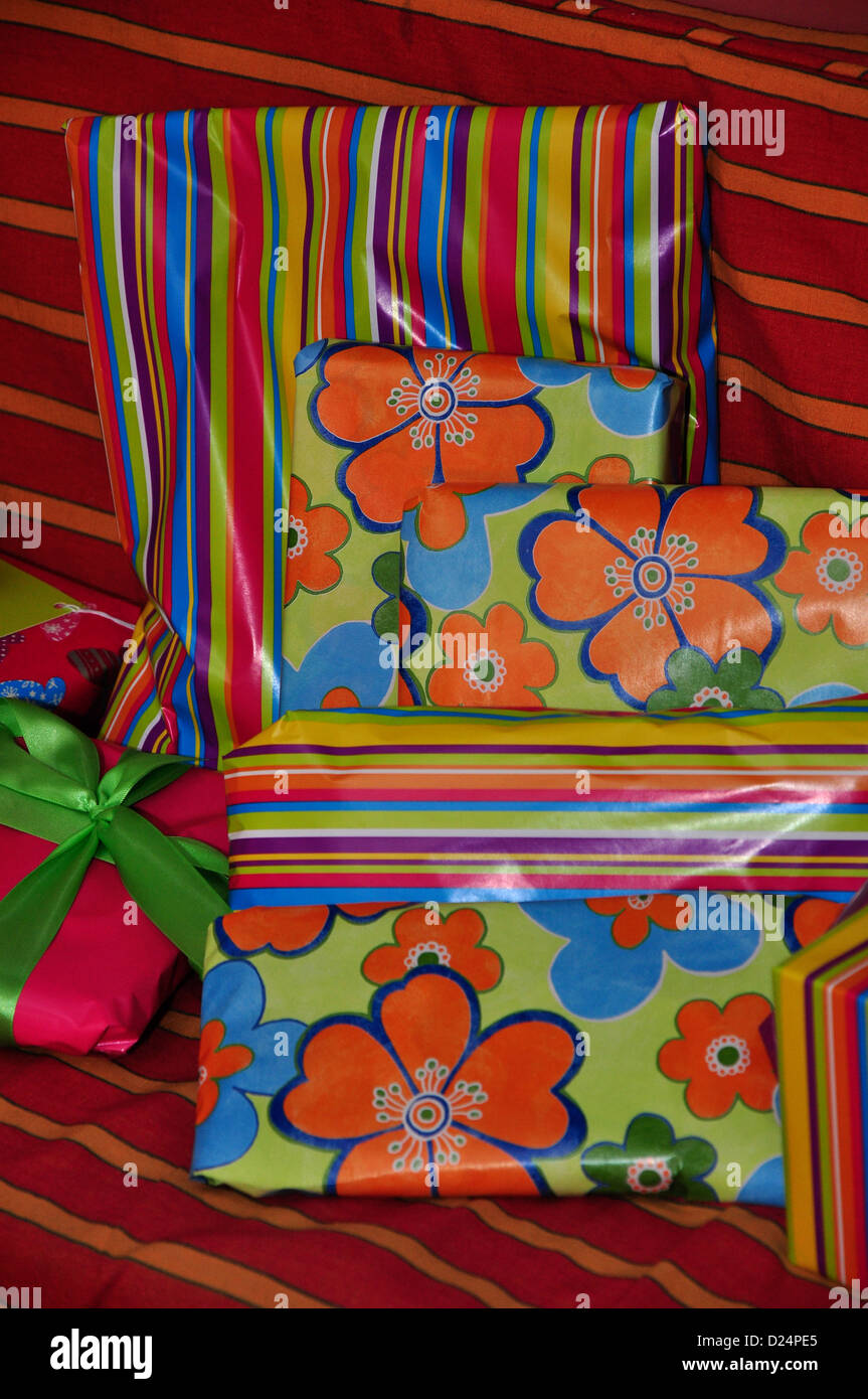 Some birthday presents wrapped in colourful paper UK Stock Photo