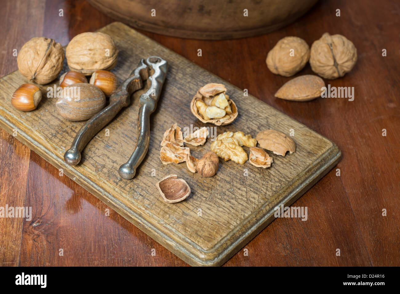 Edible nuts and nutcrackers on a table at home in a christmas setting; UK Stock Photo