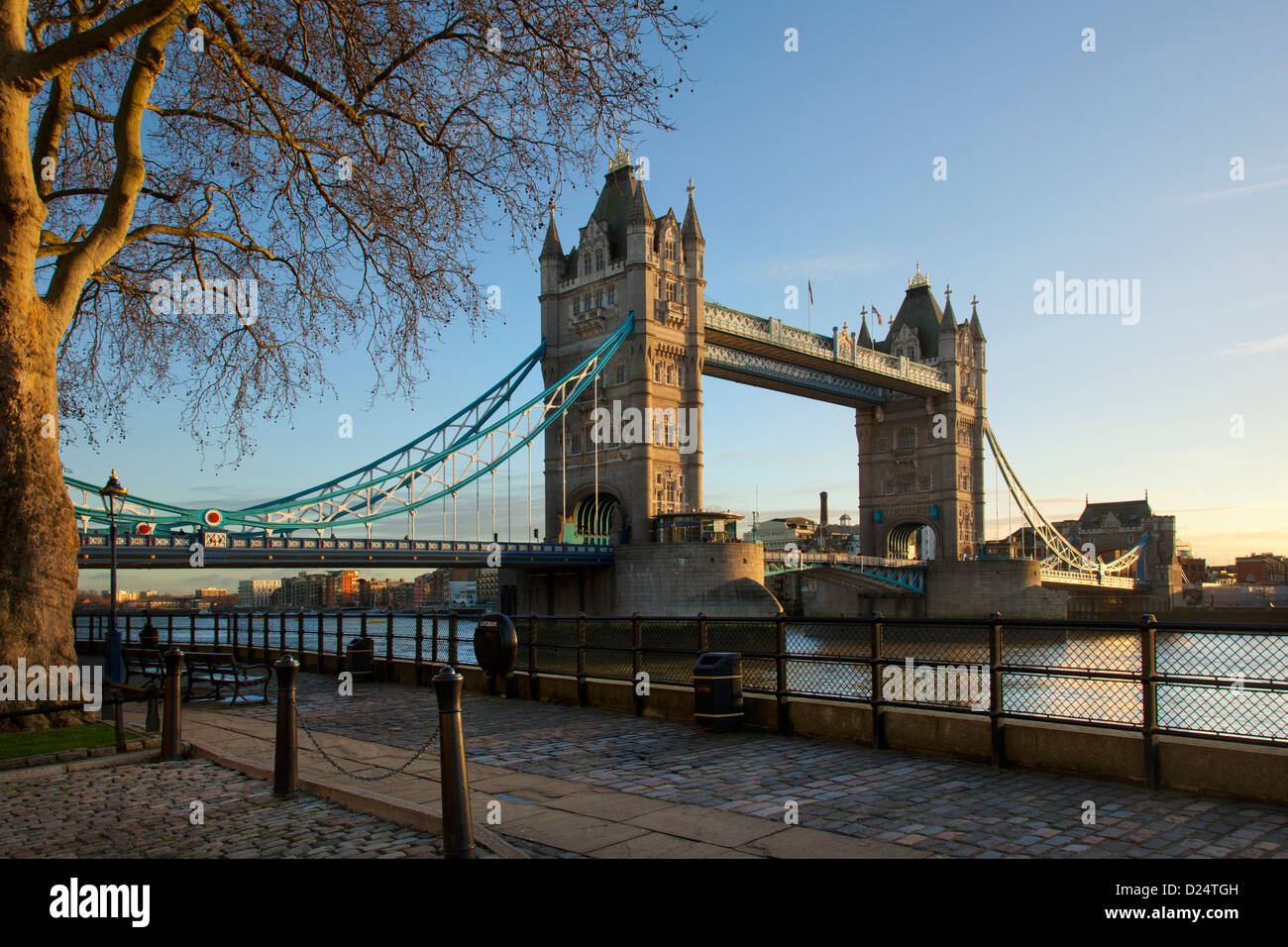 Tower Bridge in late afternoon light viewed from North side of river Thames and tower of London. Stock Photo