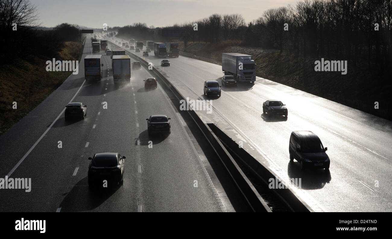 SILHOUETTED TRAFFIC ON THE M6 MOTORWAY NEAR STAFFORD RE JAMS QUEUES MOTORISTS CARS TRANSPORT LINKS LORRIES HGVS TRAVEL ROADS UK Stock Photo