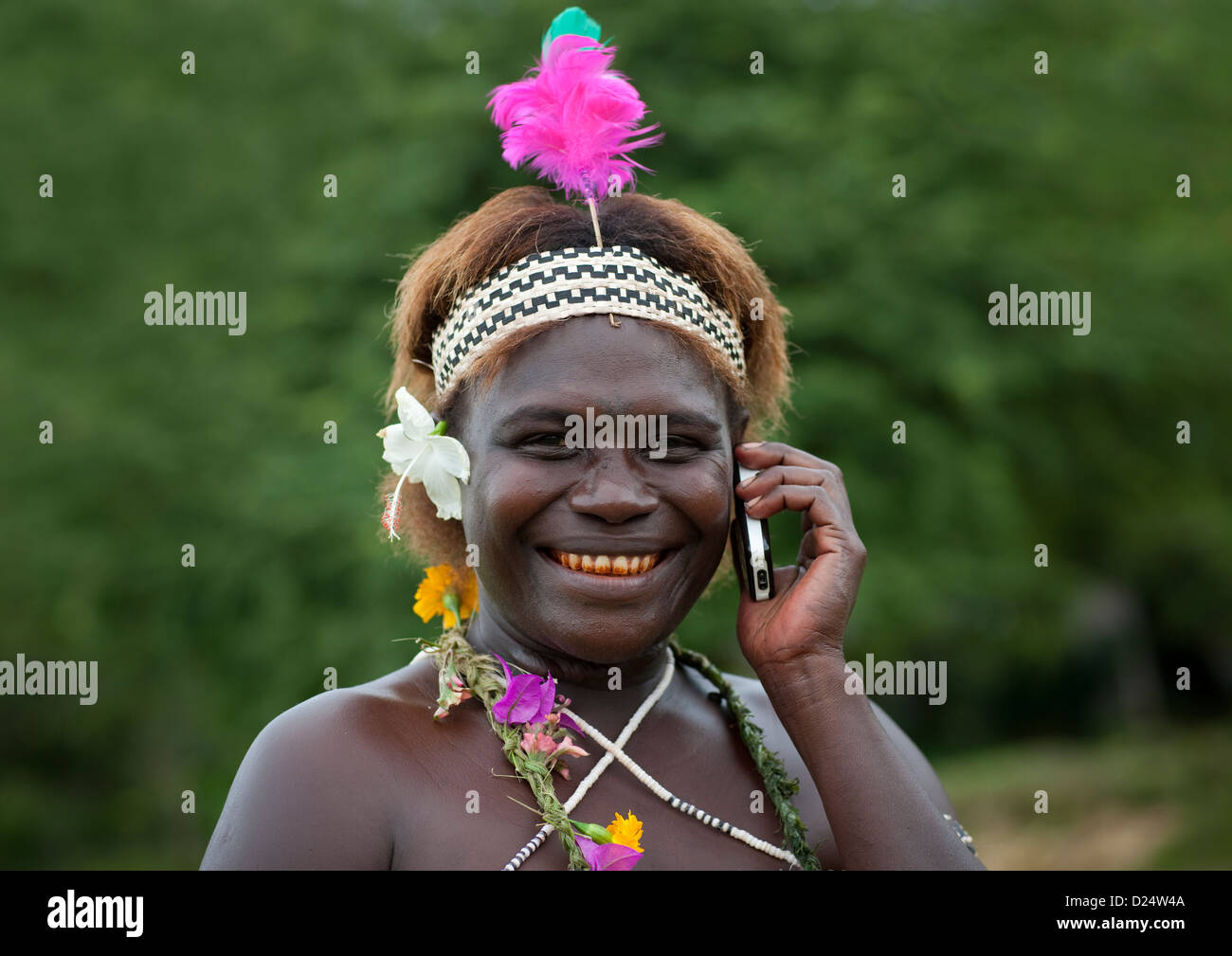Woman From Autonomous Region Of Bougainville In Traditional Clothes Speaking On The Phone, Papua New Guinea Stock Photo