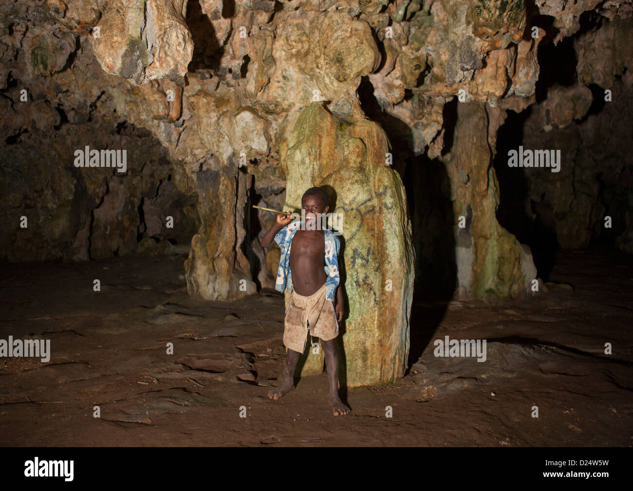 Kid Inside Momuni Sacred Cave. Bougainville, Papua New Guinea Stock Photo