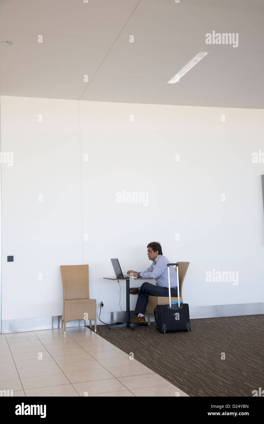 Passenger using a computer laptop at Airport Stock Photo Alamy
