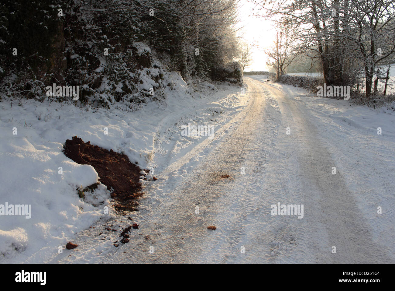 Grit and salt heap left on roadside by council in rural area during snowy conditions, North Wales, december Stock Photo