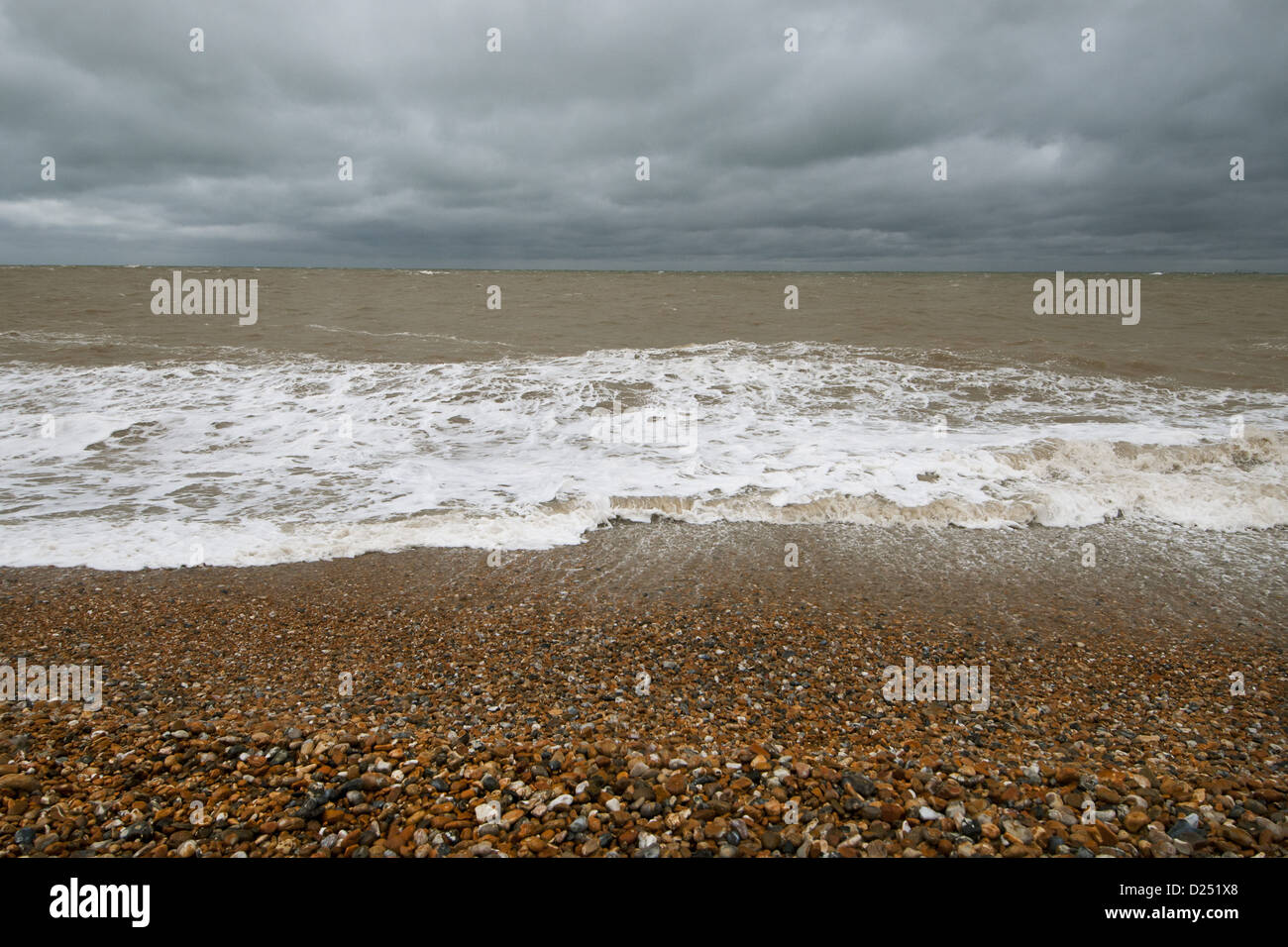 Waves crashing against shoreline of shingle beach, Dungeness, Kent, England, June Stock Photo