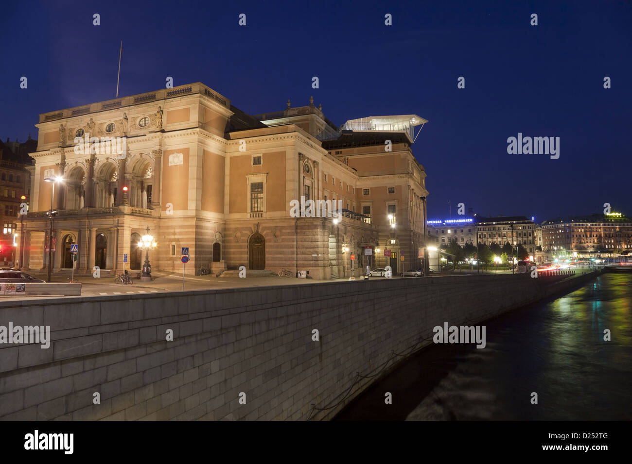 City opera house illuminated at night, Royal Swedish Opera, Norrstrom River, Stockholm, Sweden, September Stock Photo