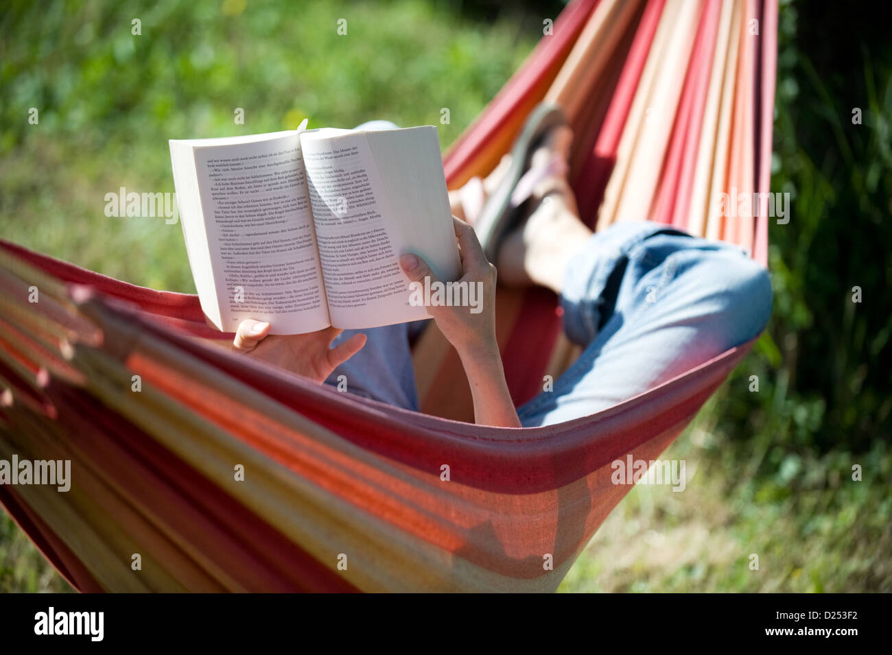 Vacqueyras, France, a woman is reading and relaxing in a hammock Stock Photo