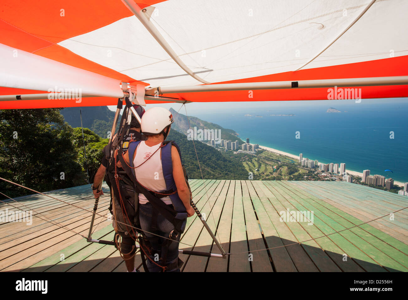 Brazil, Rio, Tijuca forest, tandem hang-gliders preparing to take-off at Pedra Bonita rock above Sao Conrado beach. View of beach & Atlantic Ocean Stock Photo