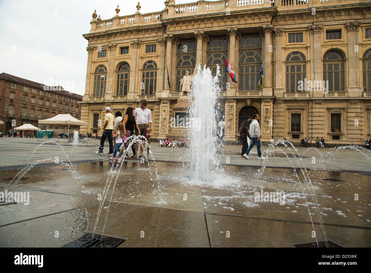 Water fountain in Piazza Castello with Palazzo Madama which houses the Civic Museum of Ancient Art in Turin Italy. Stock Photo