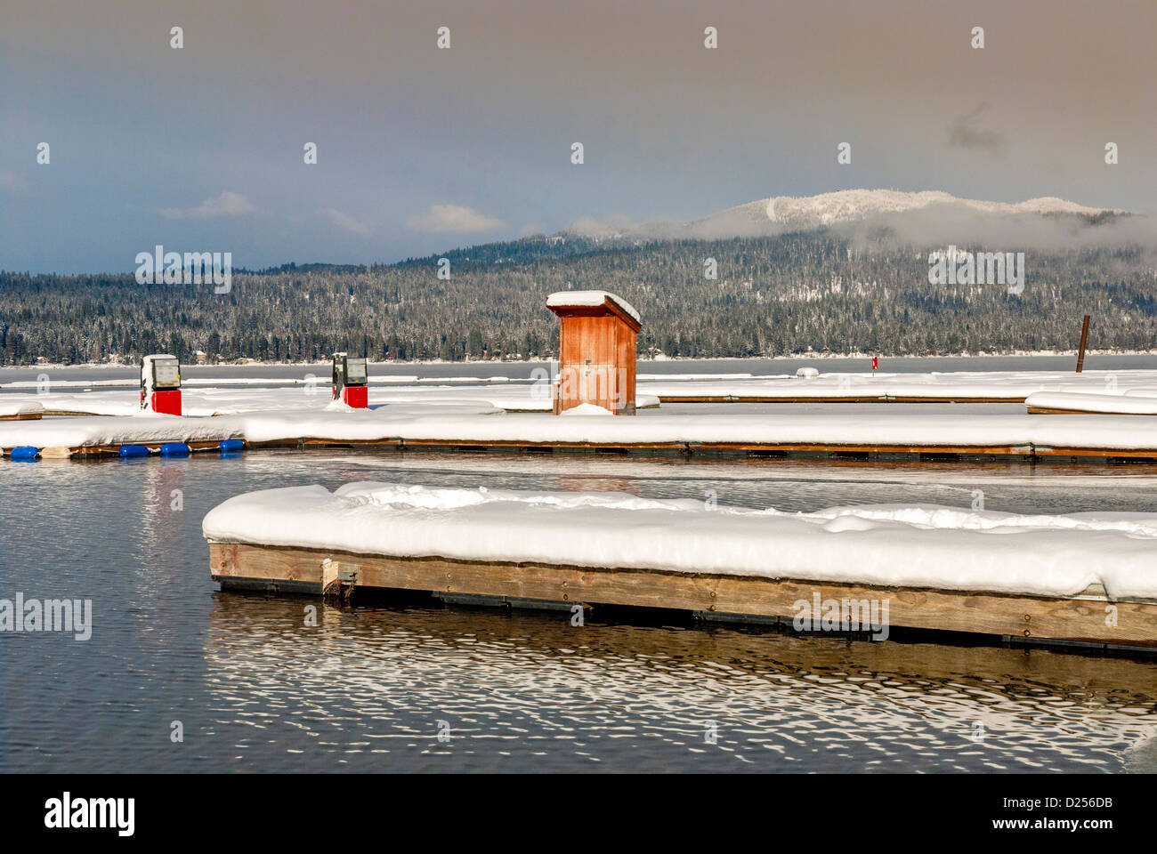 Mountain lake winter with gas pumps on a doc Stock Photo