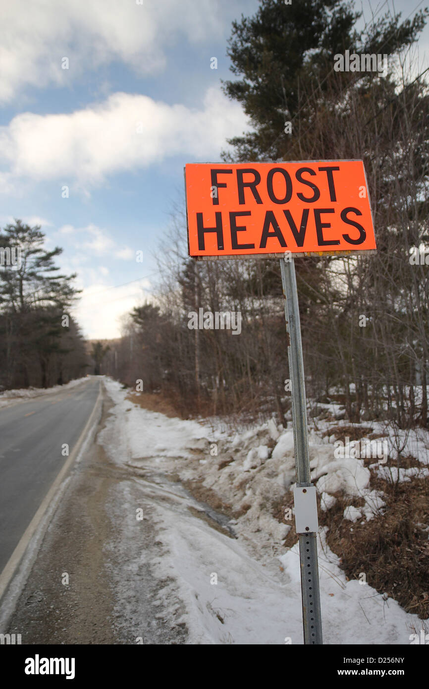 'Frost heaves' sign on a New Hampshire road in winter Stock Photo