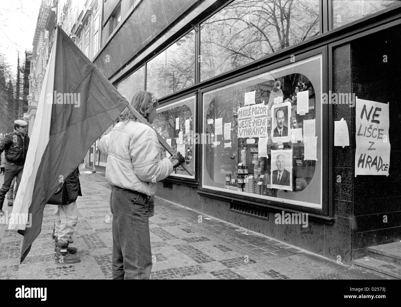 November 1989 Velvet Revolution. Demonstrator looking at portraits of Alexander Dubcek and Mikhail Gorbachev in Wenceslas Square Stock Photo