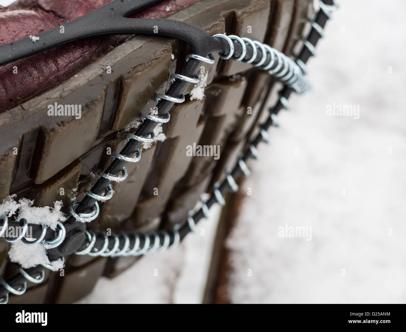 Boot sole with steel coil snow grips being worn in snowy weather in England 2013 Stock Photo Alamy