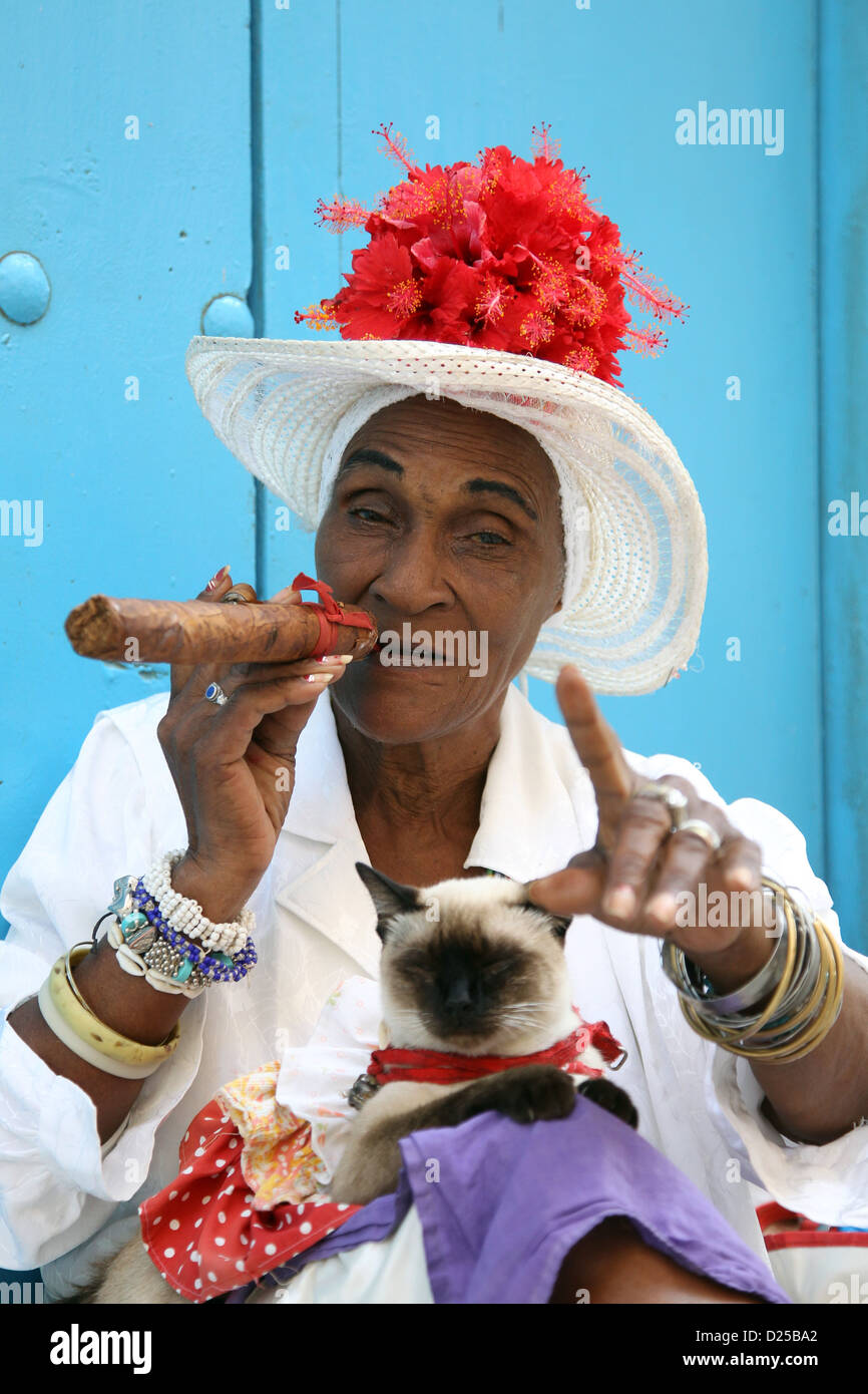 An elderly lady smokes and sells Cuban cigars in Havana, Cuba, 23 January 2012. Photo: Friso Gentsch Stock Photo