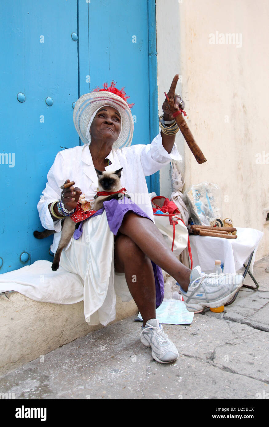 An elderly lady smokes and sells Cuban cigars in Havana, Cuba, 23 January 2012. Photo: Friso Gentsch Stock Photo