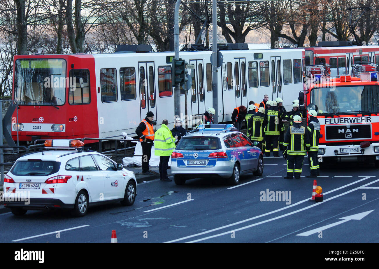 Rescue workers stand at a streetcar in Cologn, Germany, 13 January 2013. The man who was hit and fatally injured by a streetcar on Sunday in Cologne was the President of Bayreuth University, according to the university on Monday, 14 January. According to the police, 60 year-old Ruediger Bormann crossed the tracks on a red light and didn't see the streetcar. Photo: Carsten Rust Stock Photo