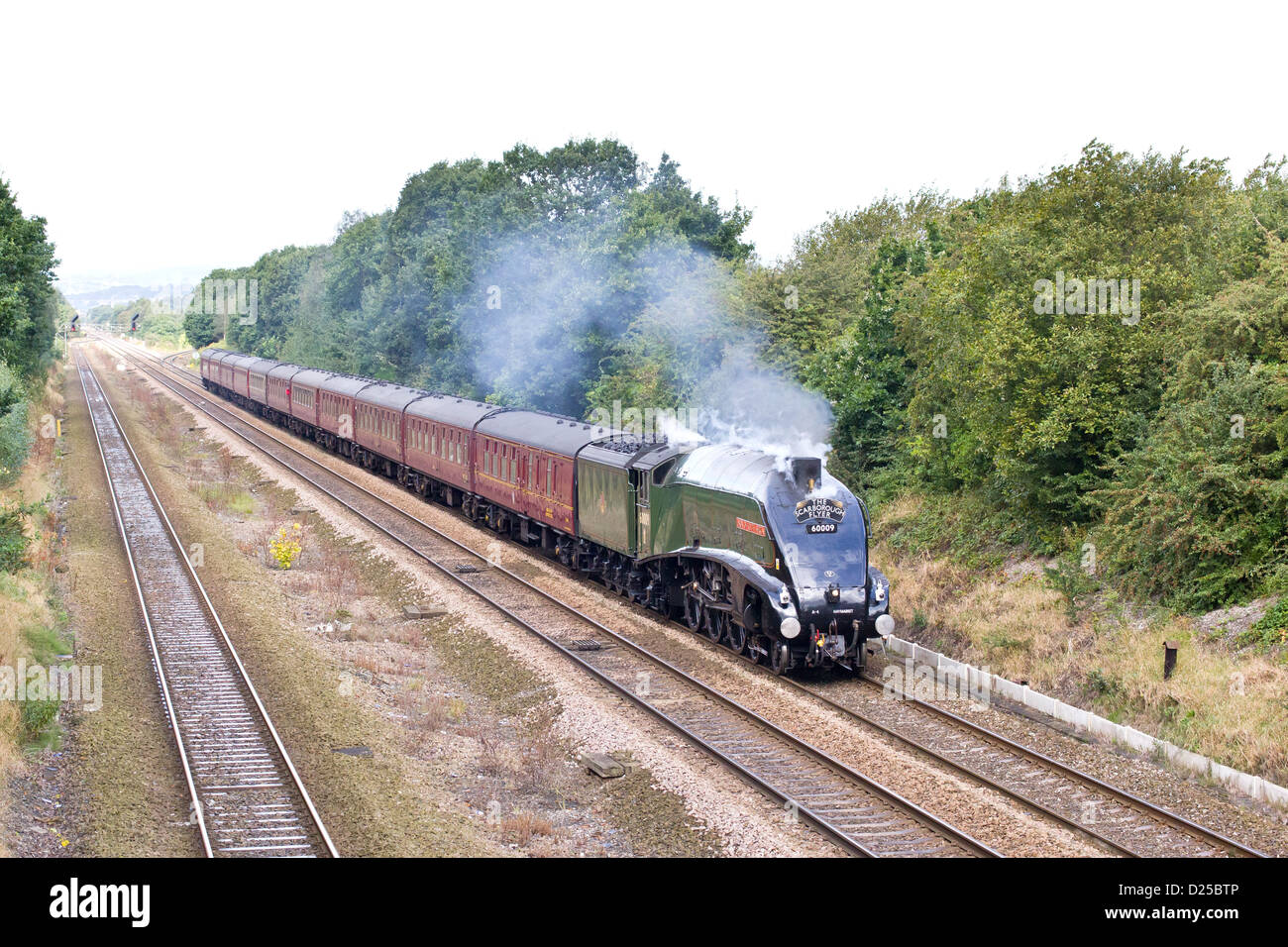 Steam locomotive pulling a passenger train on the Mainline near Mirfield Stock Photo