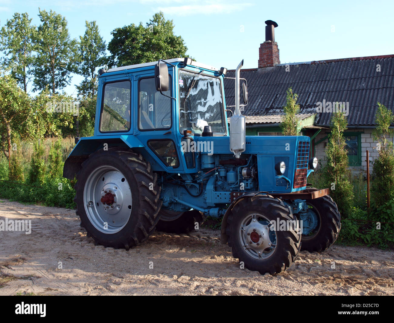Russian vintage soviet time tractor Belarus MTZ-82 with new model big cabin Stock Photo