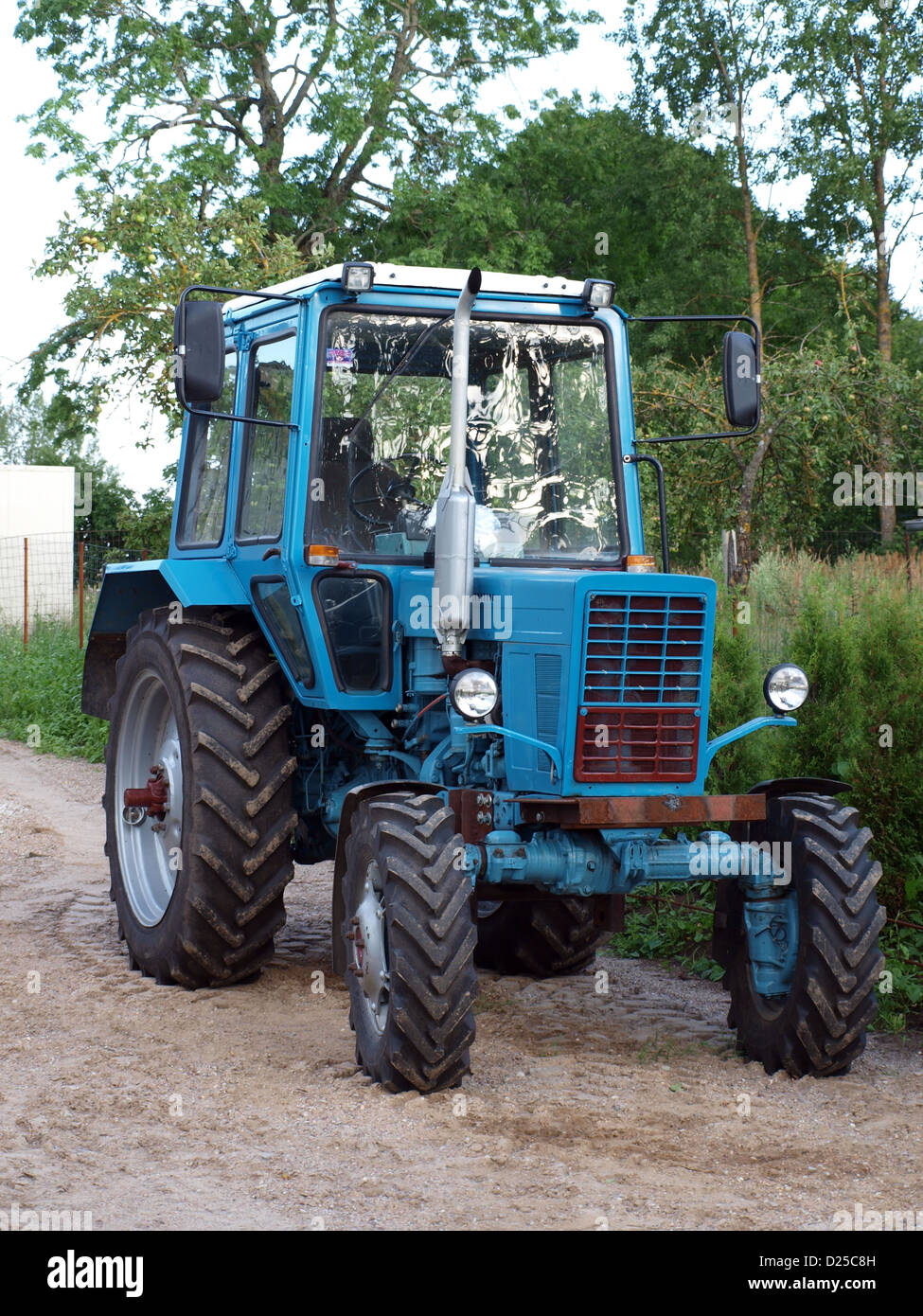 Russian vintage soviet time tractor Belarus MTZ-82 with new model big cabin Stock Photo