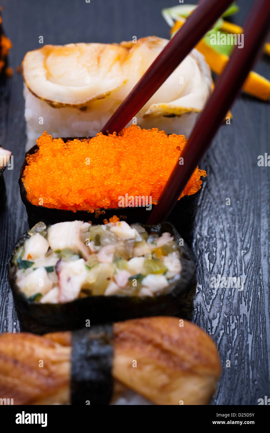 Japanese sushi on plate with chopsticks. Stock Photo
