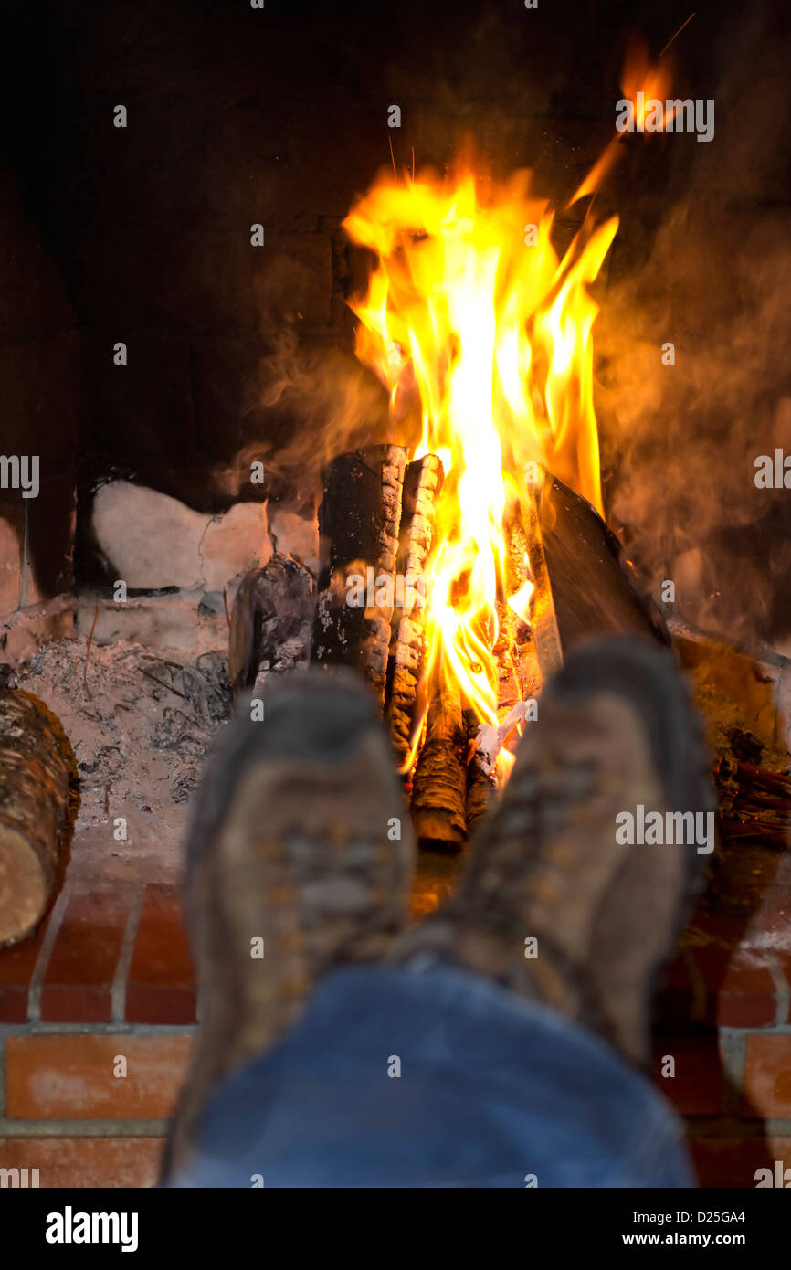 Resting by a confortable fireplace. Stock Photo