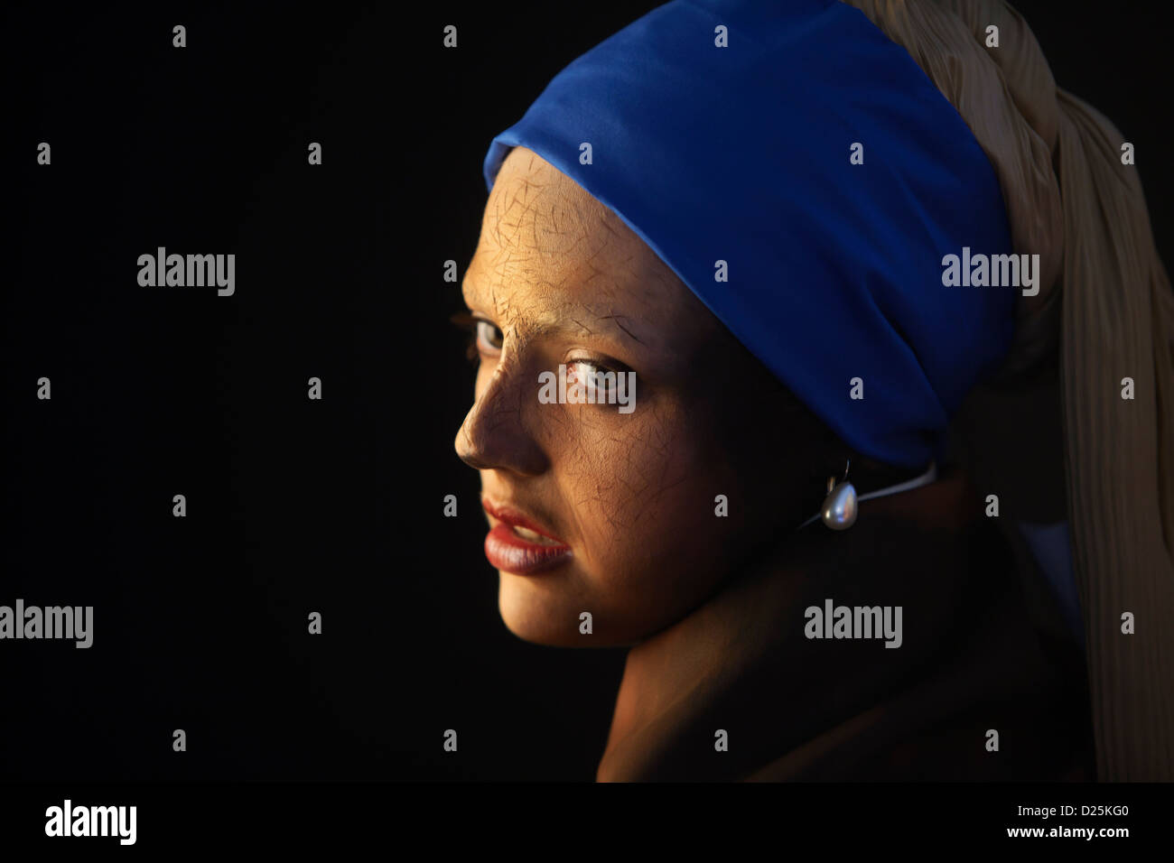 Body painted model poses as the Girl with a Pearl Earring by Dutch painter Johannes Vermeer. Stock Photo