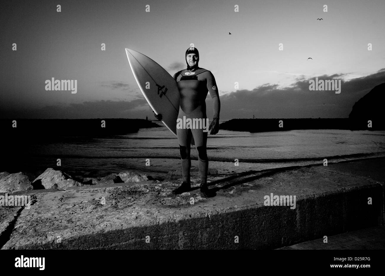 Surfer Robbie Hildreth prior to going for an early morning surf in North Yorkshire, England. Stock Photo