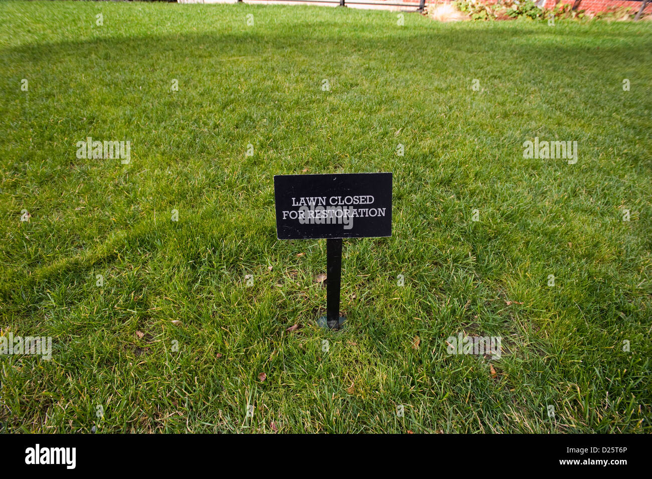 A sign saying Lawn Closed For Restoration on a piece of lawn the High Line Park, a wild life park on an old elevated railway line on Manhattan West side, New York, USA Stock Photo