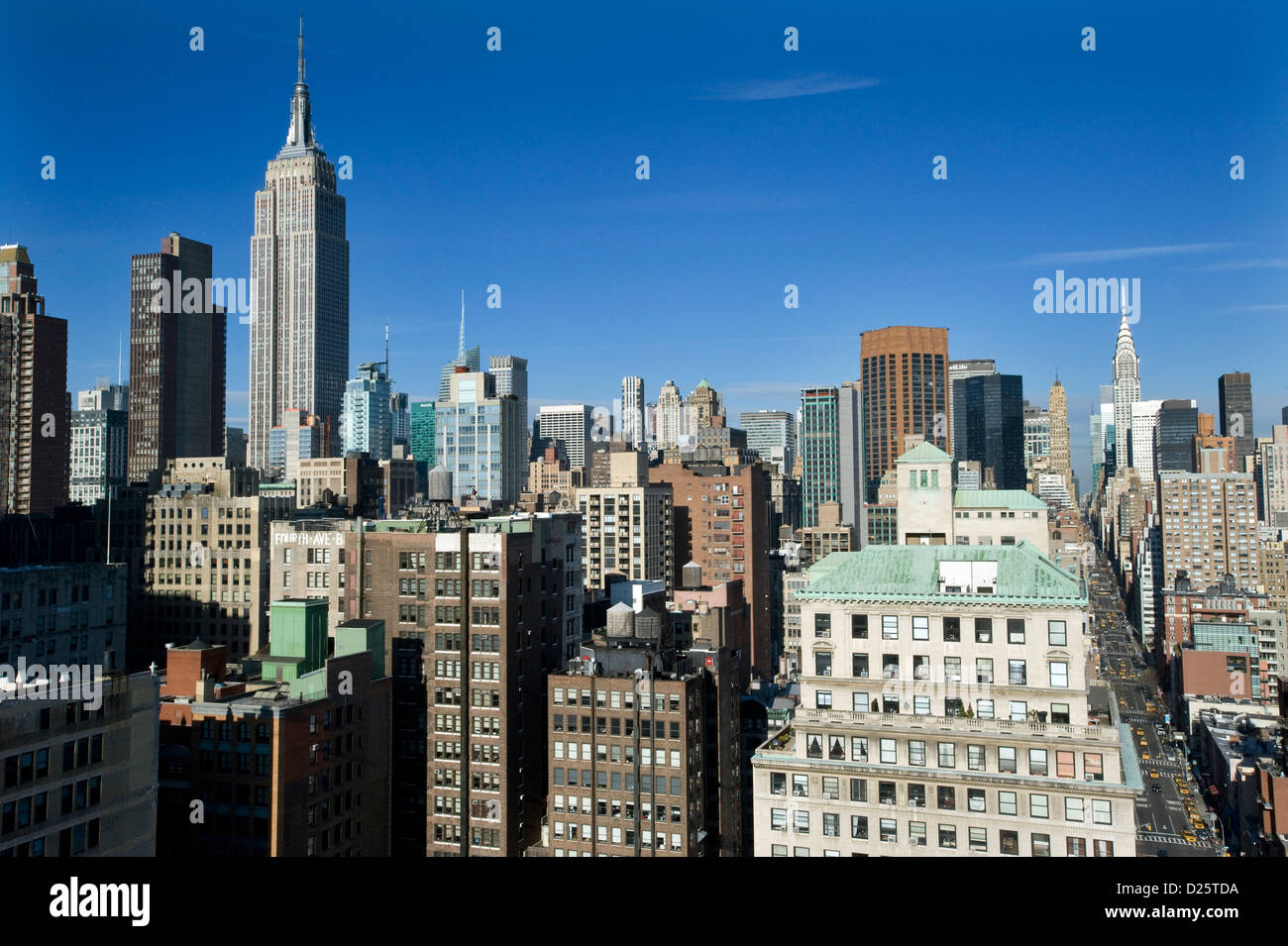 The view down Lexington Avenue,  Manhattan, New York, USA with Chrysler Building and Empire State Building on the skyline. Stock Photo