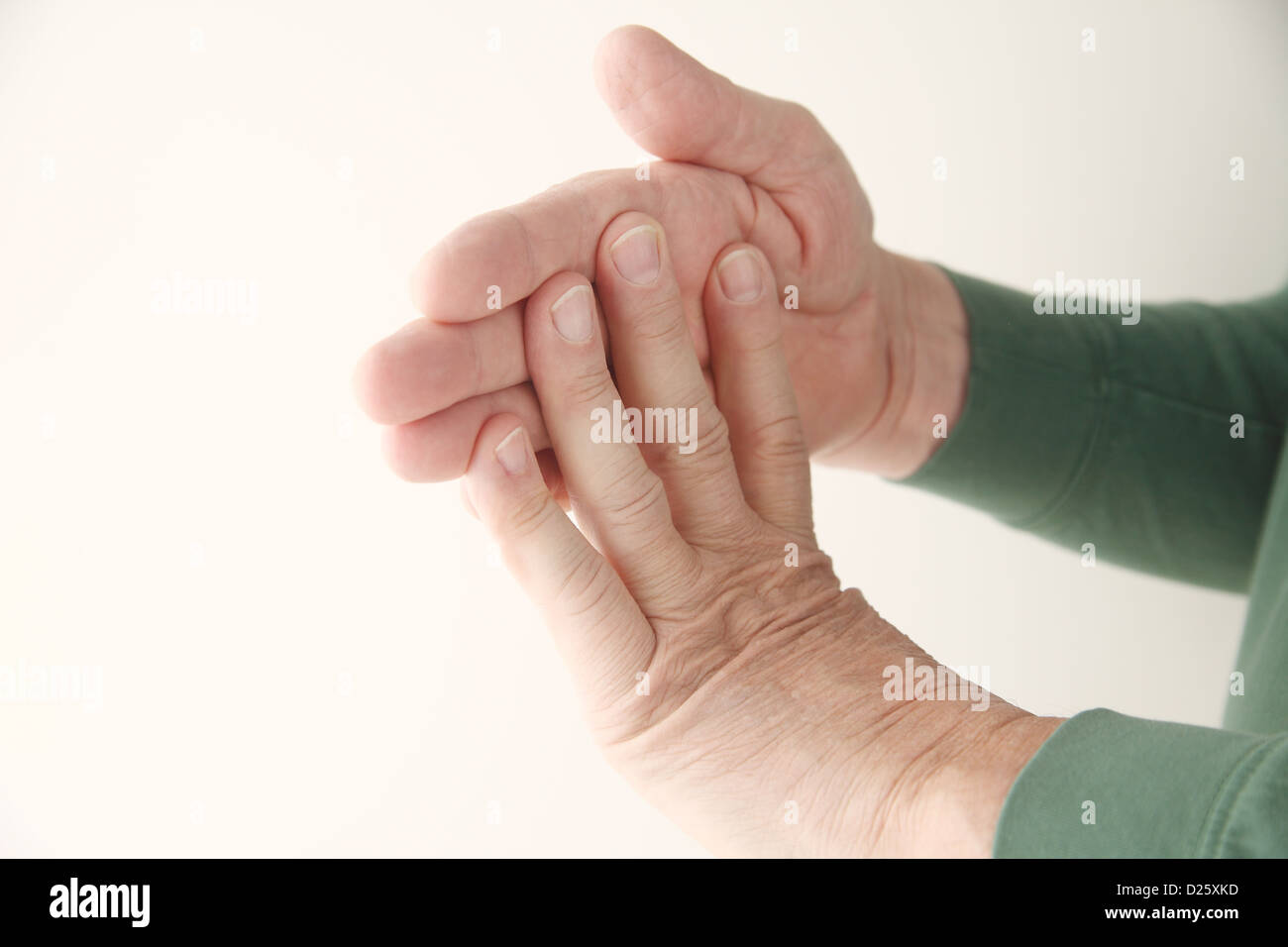 a senior man stretching his fingers Stock Photo