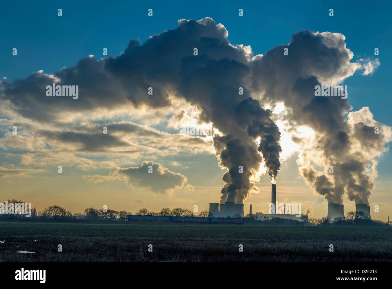 Fiddlers Ferry power station steaming in the winter sunlight producing electricity power for the National Grid. Stock Photo