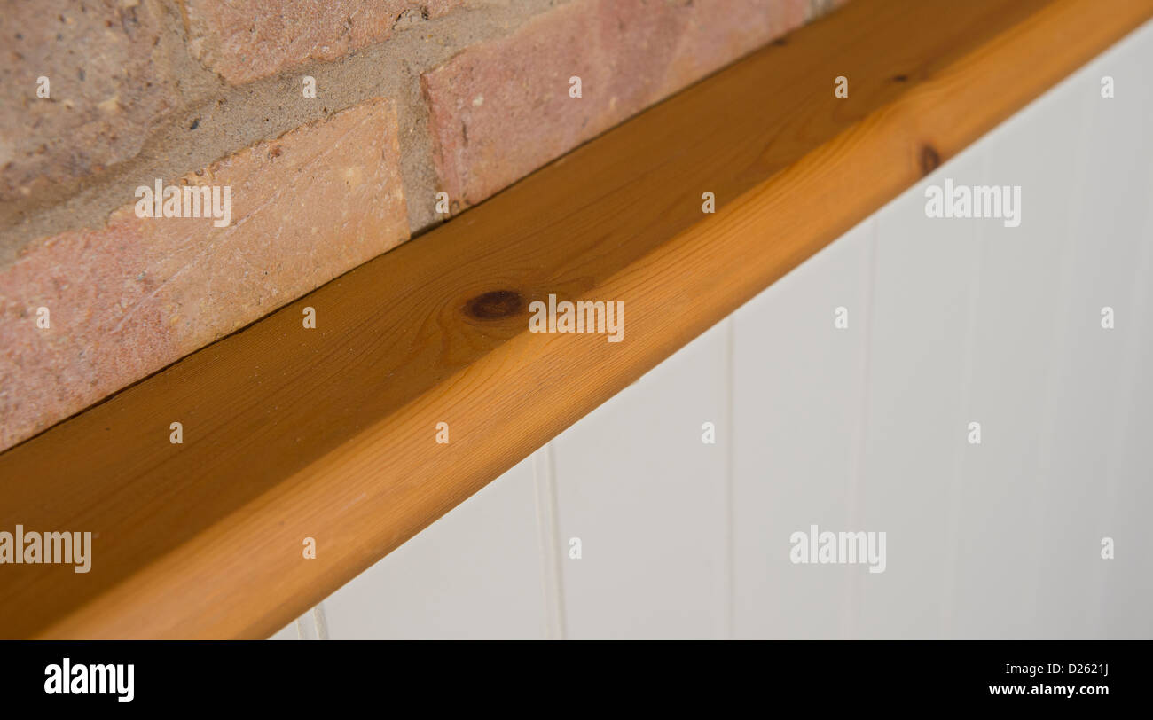 Close up of pine baton on top of painted tongue and groove panelling in a newly built house. Stock Photo