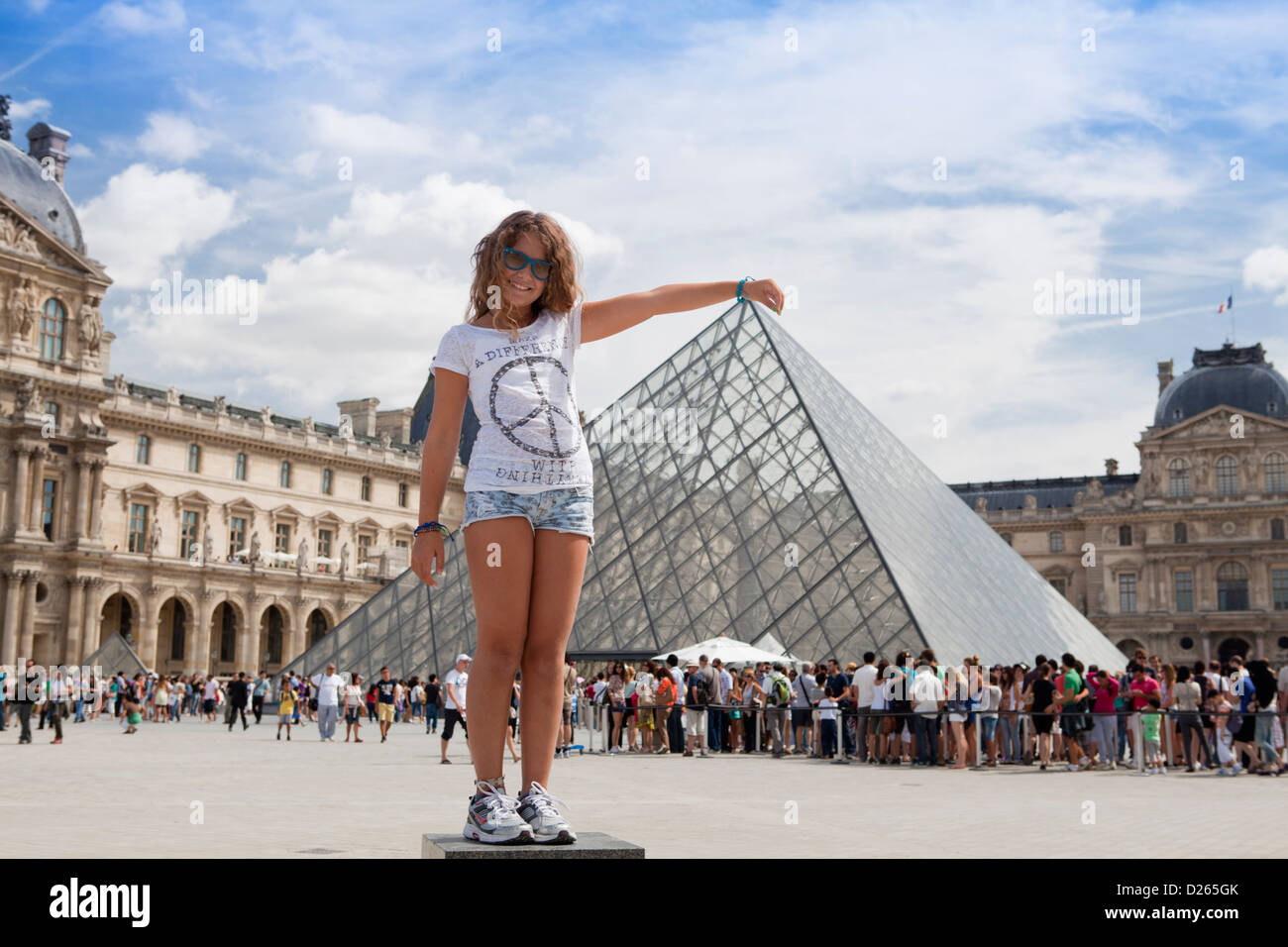 Touristic shot of the Louvre Pyramid pretending to have hand on top of it. Paris, France Stock Photo