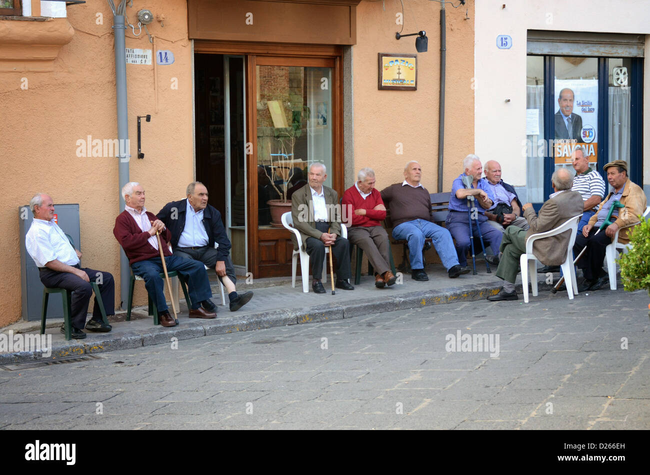 Street scenes in Castelbuono Sicily high in mountains in centre of island group of old me outside cafe Stock Photo