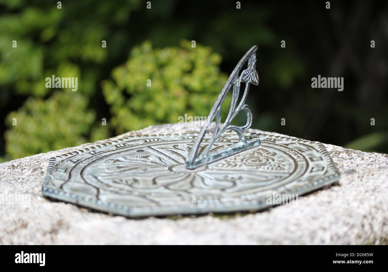 Metal sundial in garden setting Stock Photo Alamy