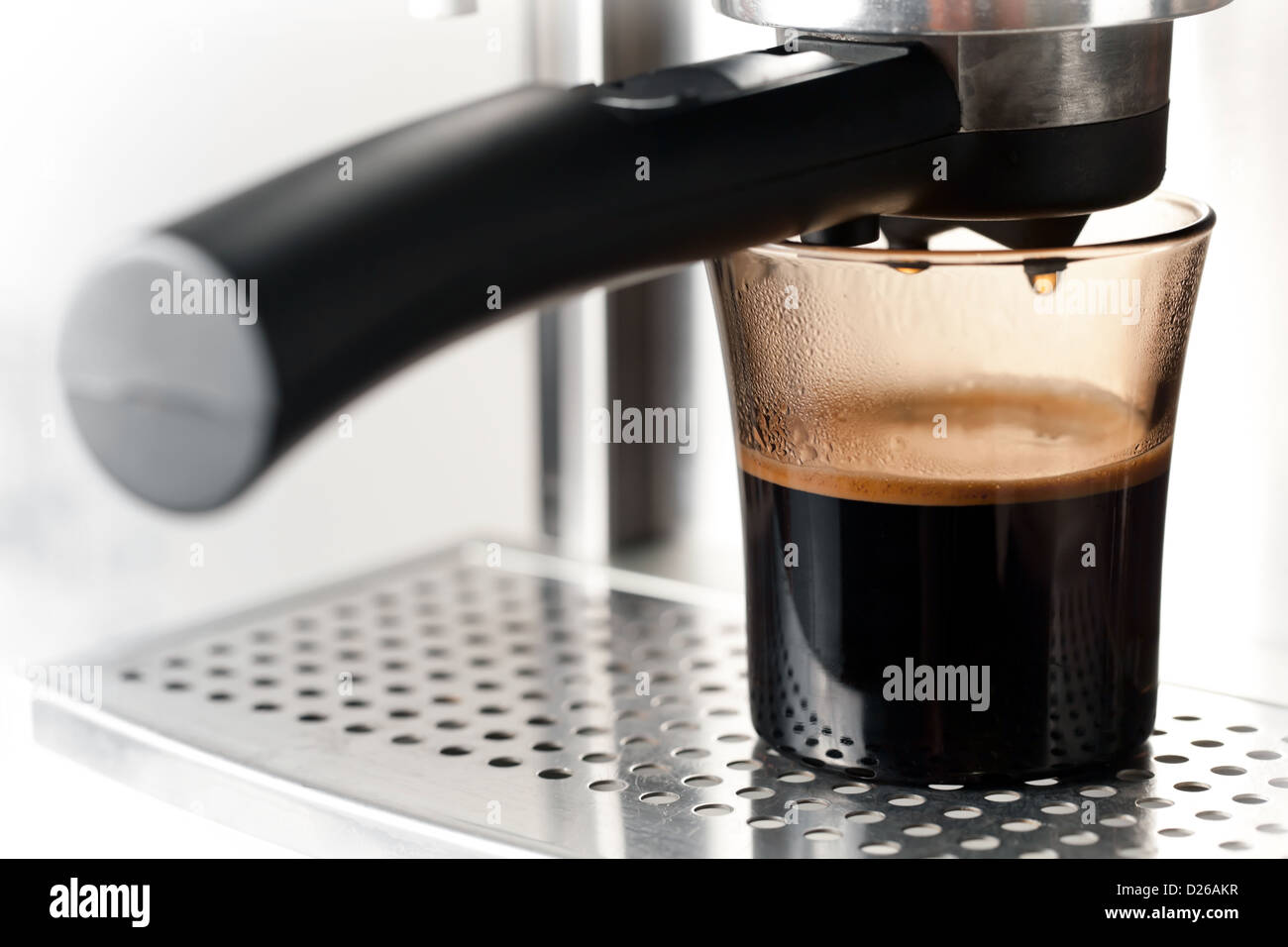 Modern glass of black coffee with espresso machine Stock Photo Alamy