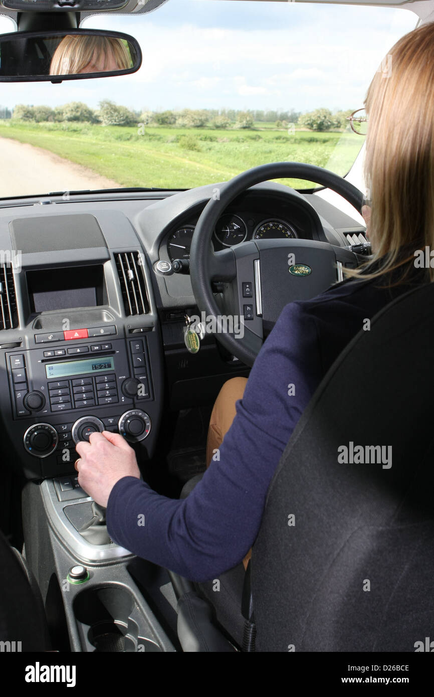 Woman driving a Land Rover Freelander 2 and changing gear Stock Photo