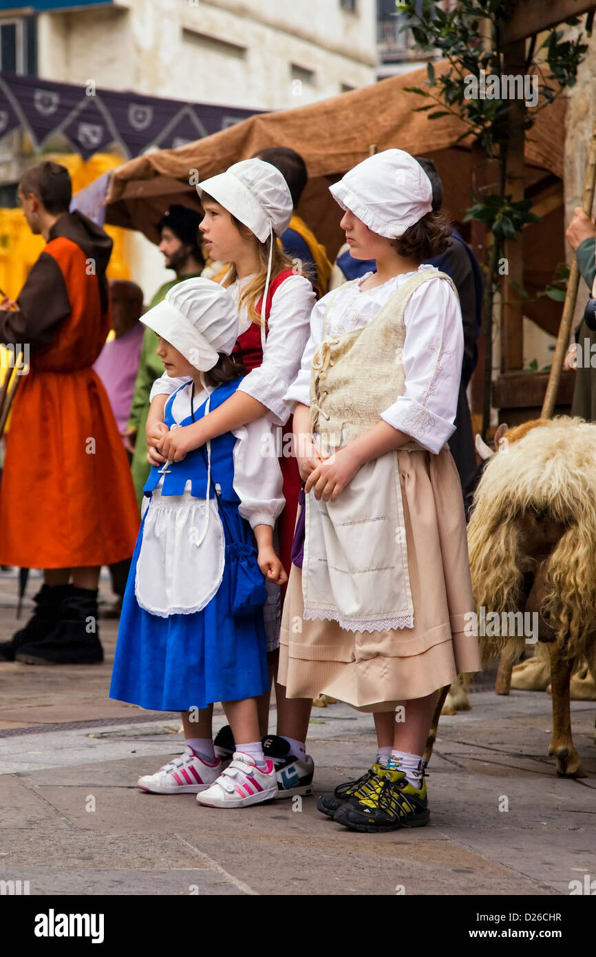 Three young girls dressed with vintage clothes and new sneakers Stock Photo