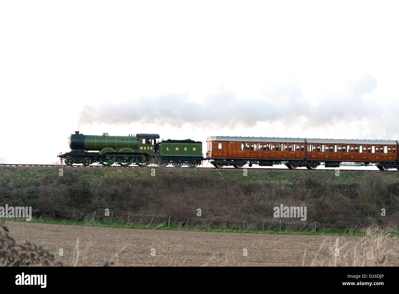 Steam pulling a passenger train on the North Norfolk Railway side view Stock Photo