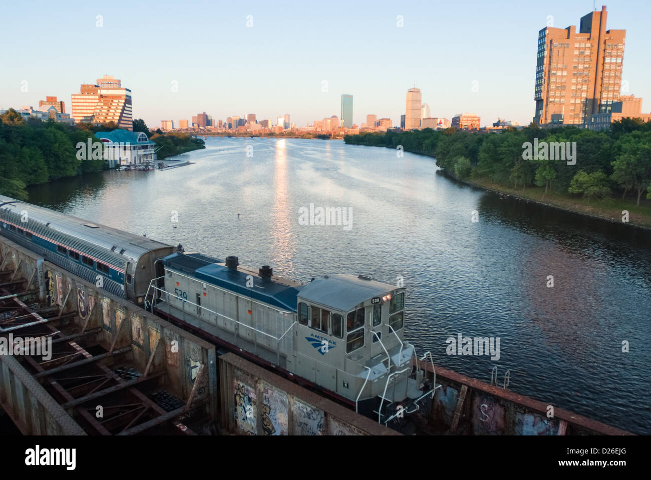 An Amtrak passenger train crosses the CSX Transportation Grand Junction Line railway bridge over the Charles RIver in Boston, MA Stock Photo